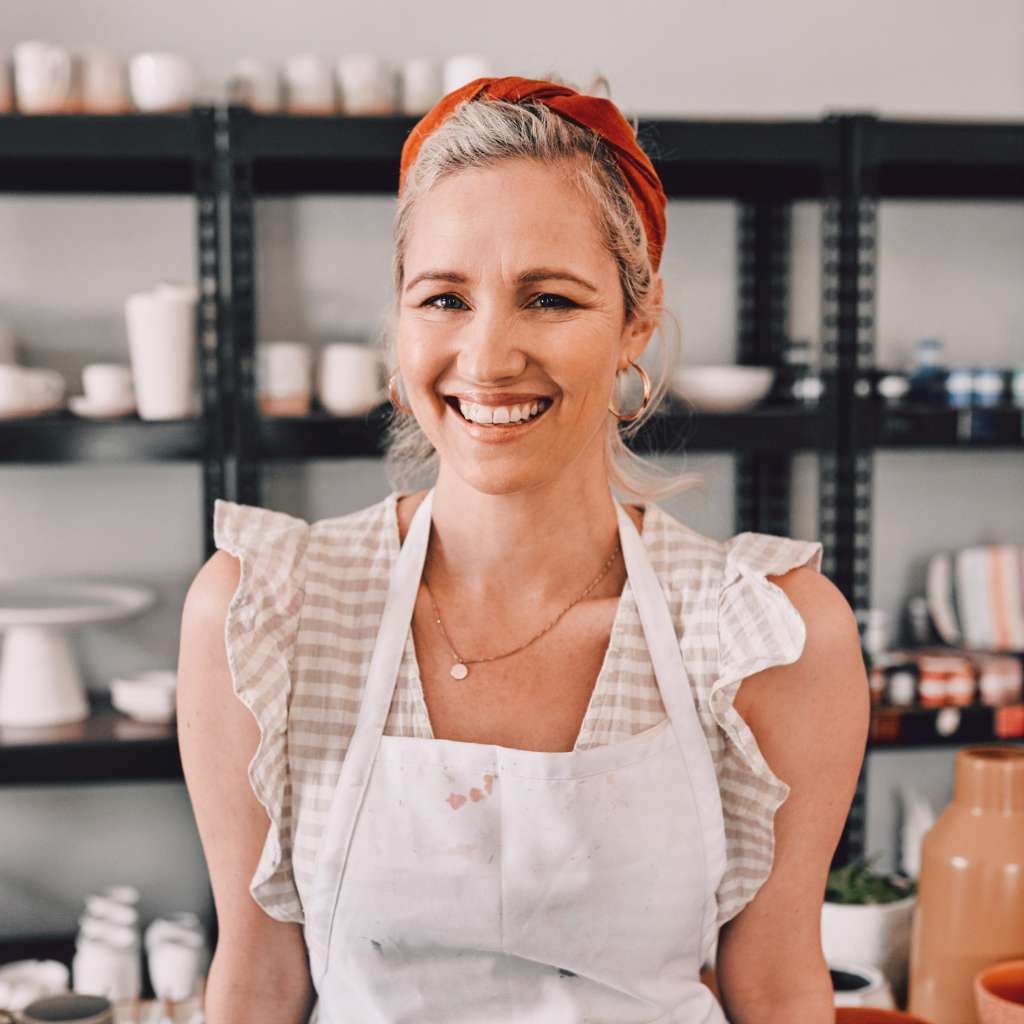 Woman wearing an apron in a pottery studio